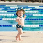 BUMKINS swimming trunks come with a hat. Swim Set has a site 6, 12, 18, 24 months.