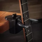 D'Addario®, which locks the guitar, clamps with the edge of the table model PW-GD-01 Guitar Dock.