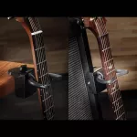 D'Addario®, which locks the guitar, clamps with the edge of the table model PW-GD-01 Guitar Dock.