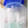 Chipper 8 ounce milk bottle, arms holding a narrow neck boots